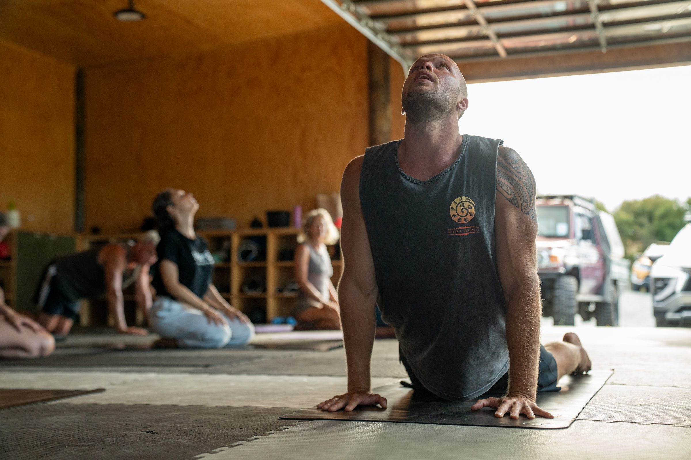 Hugo Souza leading a movement class through an upward-dog at the Black Swamp Dojo